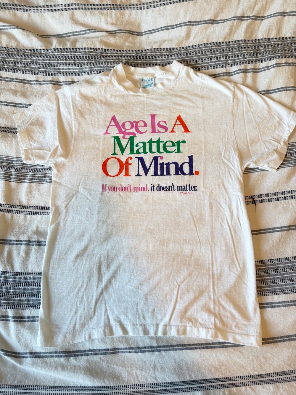 Vintage White Short-Sleeve Tee with Multicolor 'Age Is A Matter Of Mind' Graphic